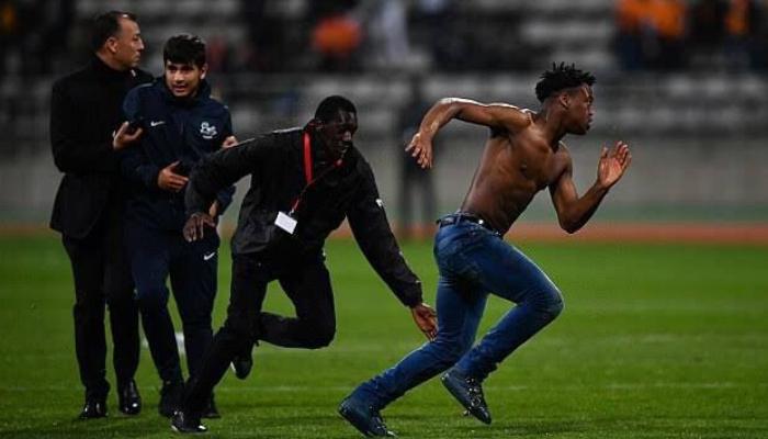 Fan running on pitch