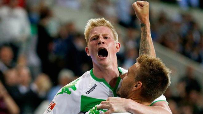 Kevin De Bruyne held up by Bendtner after they connect for a goal against Bayern Munich. 