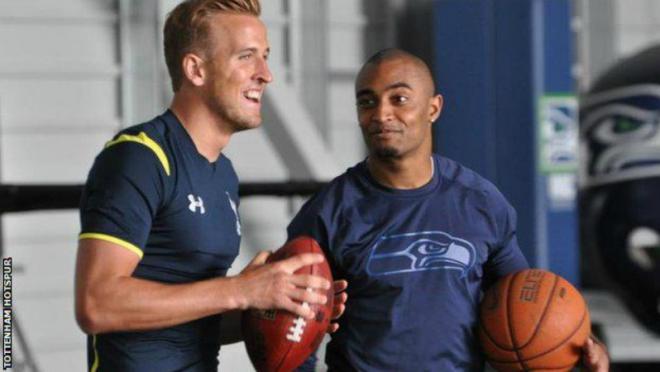 Harry Kane holding an American football. 