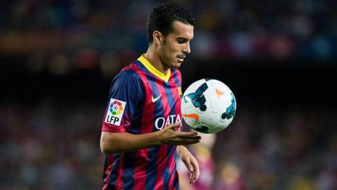 Pedro holding the ball on the field. 