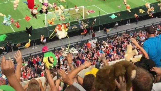 ADO Den Haag fans throw stuffed animals.