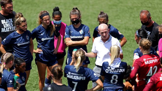 Paul Riley head coach of North Carolina Courage talks with the team