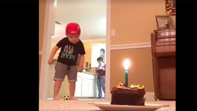 Kid extinguishes candle with soccer ball