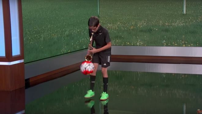 Juggling Soccer ball playing saxophone