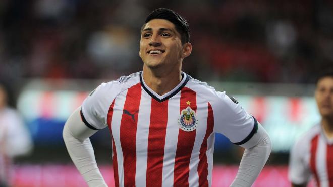 Alan Pulido smiles in his Chivas jersey.