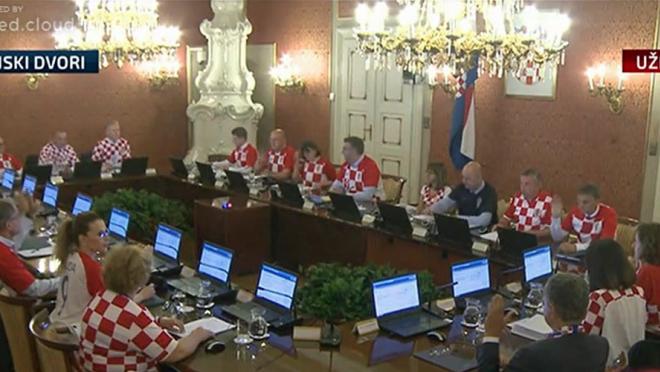 Croatia cabinet members wear Croatia jerseys during a meeting